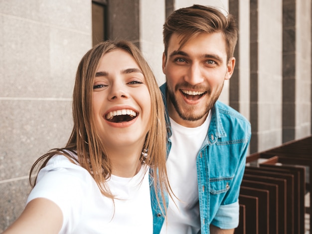 Smiling beautiful girl and her handsome boyfriend in casual summer clothes. 