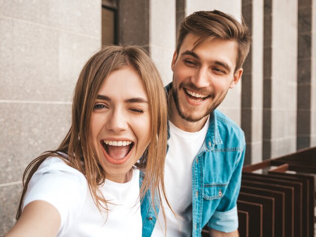 Smiling beautiful girl and her handsome boyfriend in casual summer clothes. 