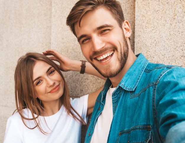 Smiling beautiful girl and her handsome boyfriend in casual summer clothes. 