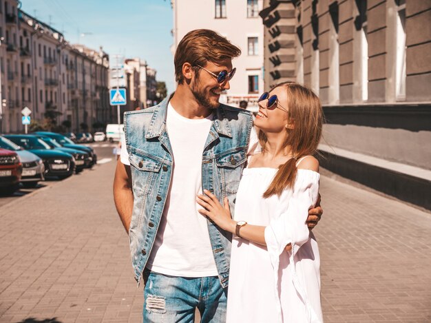 Smiling beautiful girl and her handsome boyfriend walking in the street