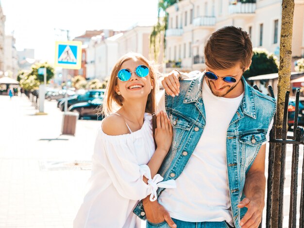 Smiling beautiful girl and her handsome boyfriend walking in the street. 