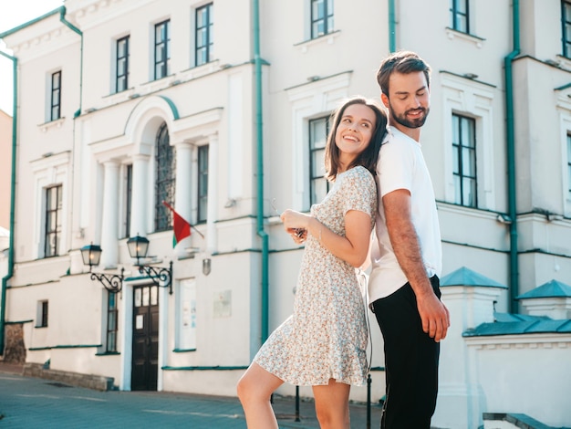 Smiling beautiful woman and her handsome boyfriend woman in casual summer clothes happy cheerful family female having fun couple posing on the street background