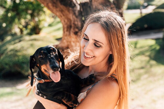 Smiling beautiful woman with her pet