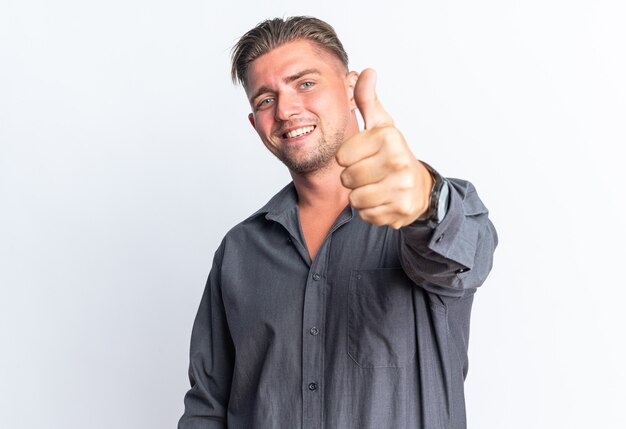 Smiling blonde handsome man thumbing up