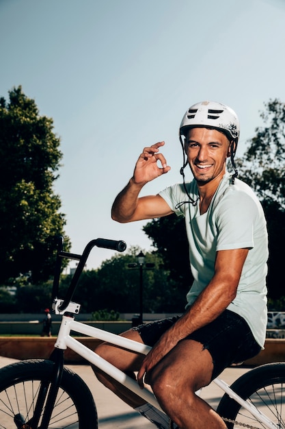 Smiling bmx rider waving at the camera