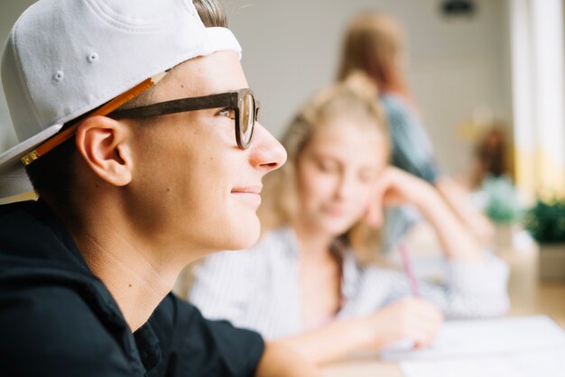 Smiling boy in glasses looking away