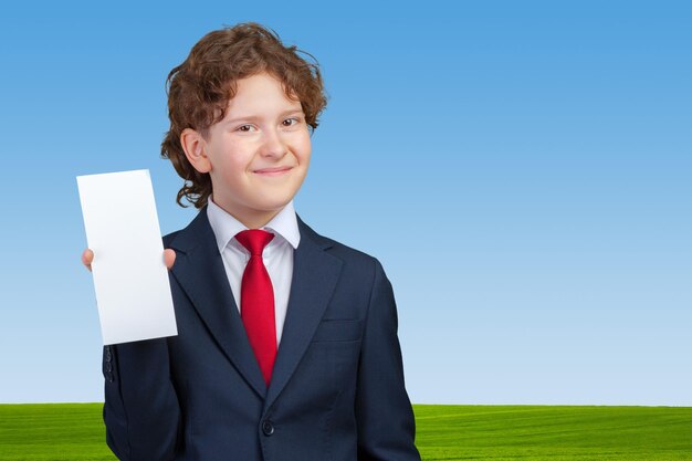 Smiling boy holding blank paper