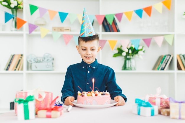 誕生日ケーキを持つ少年の笑顔