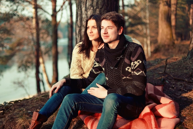 Free photo smiling boyfriend touching his girlfriend's knee