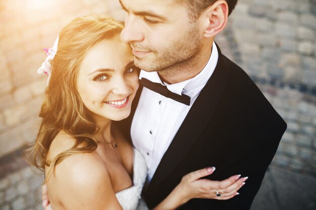 Smiling bride embracing her husband