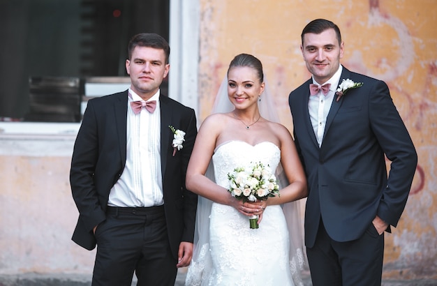 smiling bride posing with groomsmen