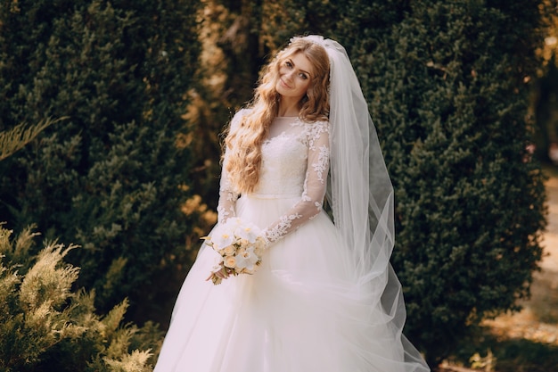 Smiling bride with a boiquet