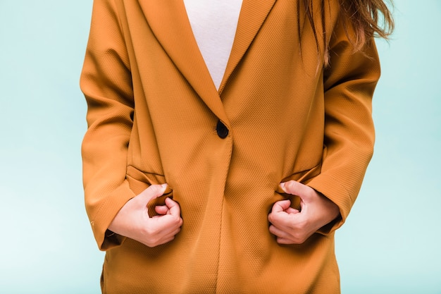 Smiling brunette girl posing with coat