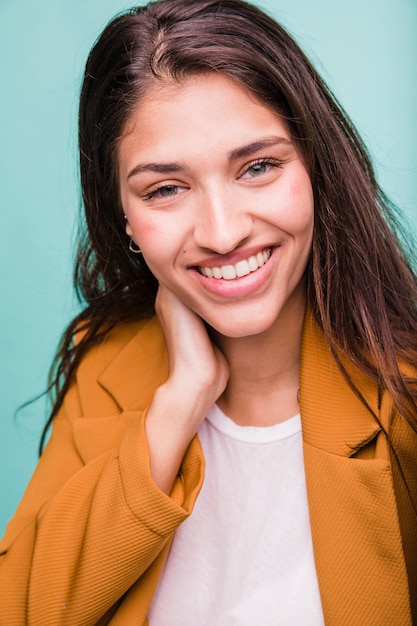 Smiling brunette girl posing with coat