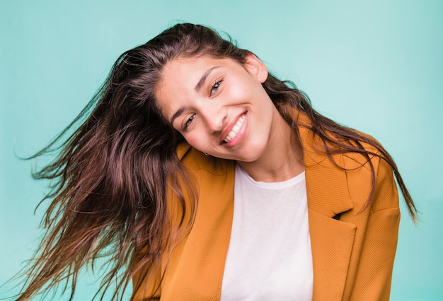 Smiling brunette girl posing with coat