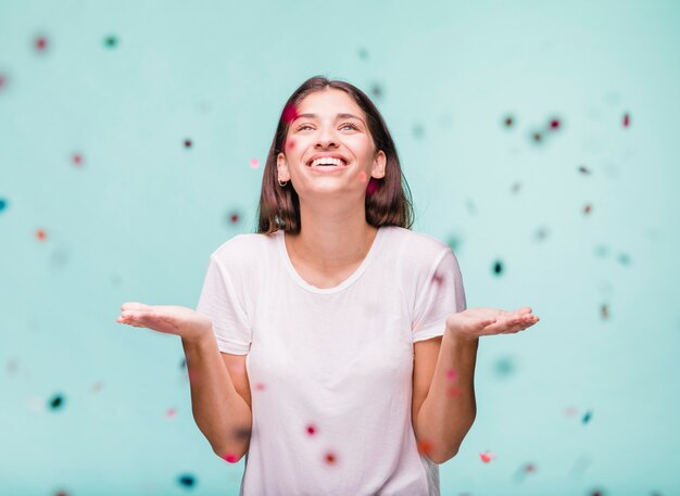 Smiling brunette girl with confetti