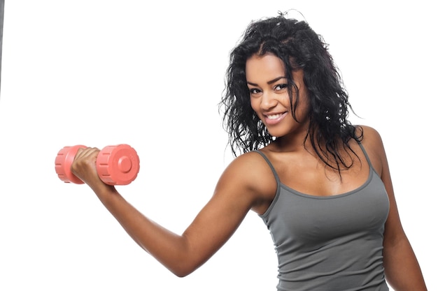 Free photo smiling brunette woman in grey t shirt holds pink dumbell. isolated on white background.