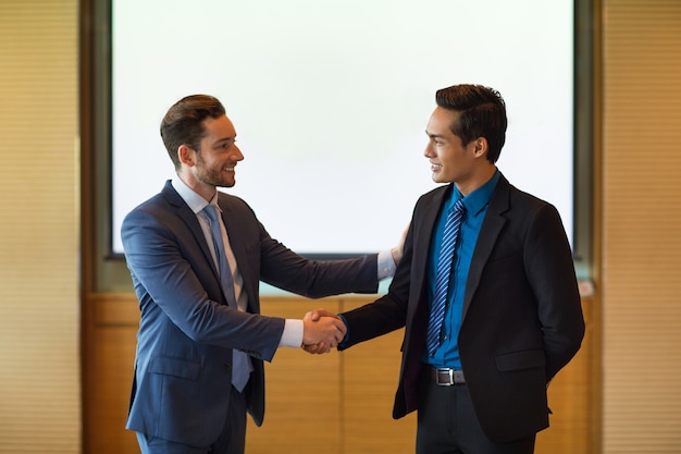 Smiling Business Leader Greeting Partner