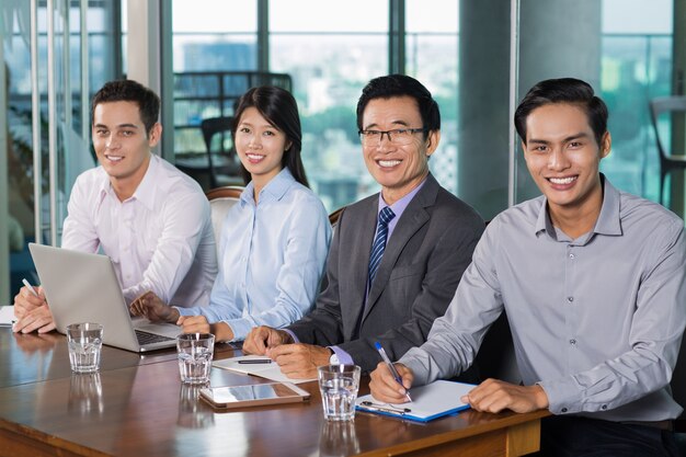 Smiling Business People Holding Meeting in Office