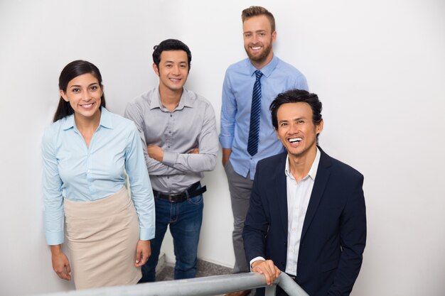 Smiling Business Team Gathering on Office Stairway