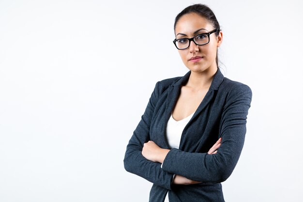 Smiling business woman crossing arms. Isolated on white.