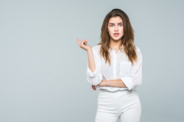 Smiling business woman shocked with up hands against white background. Toothy smile, crossed arms.