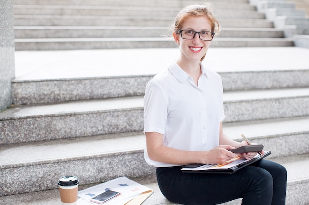 Smiling Business Woman Working on Stairs