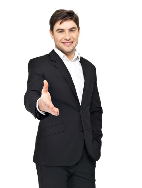 Smiling businessman in black suit gives handshake isolated on white.
