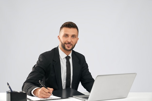 Smiling businessman doing paperwork