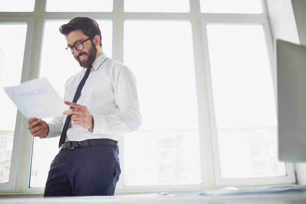 Smiling businessman holding a sketch