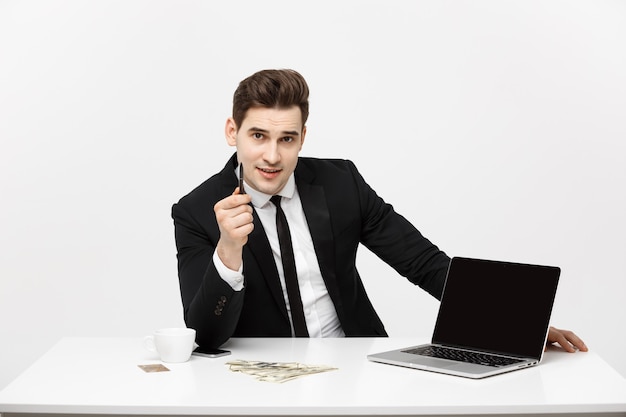 Smiling businessman presenting his laptop computer to the viewer with a blank screen with copy space