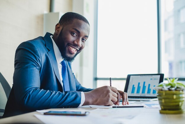 Smiling businessman signing contract