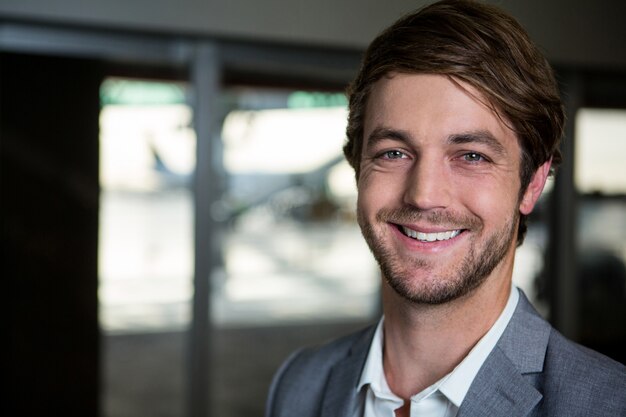 Smiling businessman standing at airport