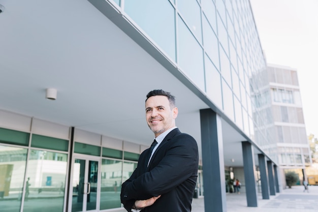 Smiling businessman with arms crossed