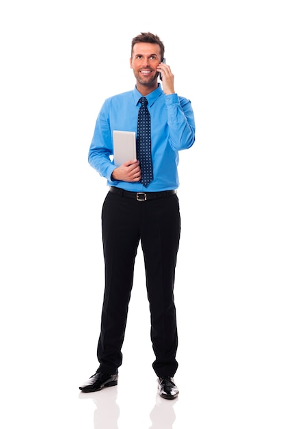 Smiling businessman with electronic equipment