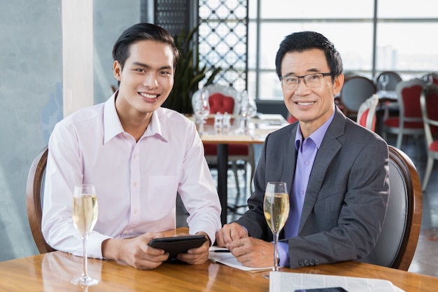 Smiling Businessmen with Glasses of Champagne