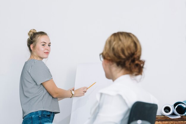 Smiling businesswoman explaining new business plan to her colleague