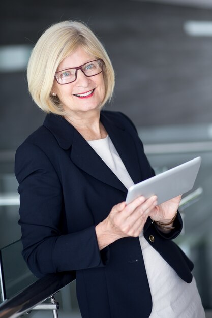 Smiling businesswoman holding digital tablet