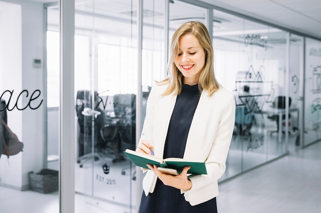 Smiling businesswoman reading