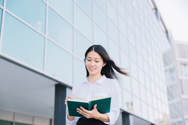 Smiling businesswoman reading