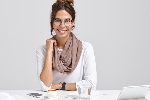 Smiling businesswoman in round spectacles