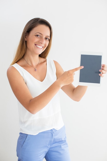 Smiling businesswoman showing digital tablet