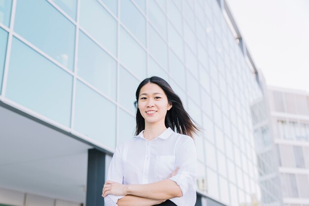 Smiling businesswoman with arms crossed