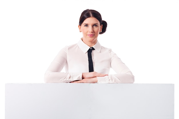 Smiling businesswoman with empty white board