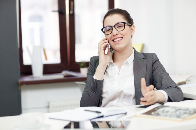 Smiling Businesswoman with Mobile Phone