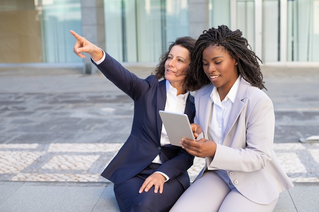 Smiling businesswomen using tablet pc