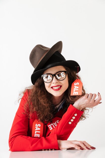 Smiling cheerful sale shopping woman wearing sale signs