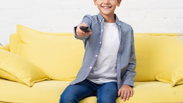 Smiling child holding a remote control