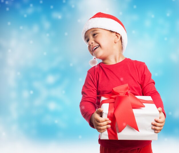 Smiling child holding a white gift