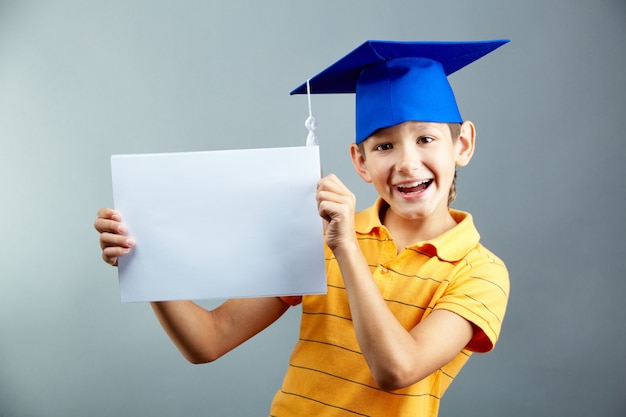 Smiling child with a blank sign